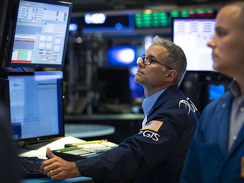 Traders work on the floor of the New York Stock Exchange. As markets worldwide cautiously await the fast-approaching elections in the world’s top economy, skewing the balance are topics surrounding further stimulus and new COVID-19 infections.