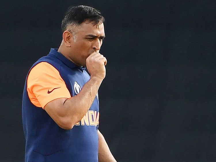 India's MS Dhoni reacts after being hit on the thumb