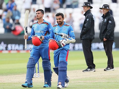 Afghanistan's Mujeeb Ur Rahman, left, and Sayed Shirzad leave the field after their loss against West Indies in the World Cup match at Headingley in Leeds. 