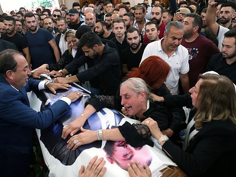 The mother and relatives of Rami Salman, one of two aides of Refugee Affairs Minister Saleh al-Gharib who was killed on Sunday in an incident that Gharib called an assassination attempt, during his funeral in Ramlieh, Lebanon July 5, 2019. 