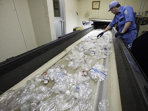 HOLD FOR STORY SLUGGED   BY MARI YAMAGUCH ; Employee work at the Tokyo Petbottle Recycle Co.,Ltd in Tokyo, Tuesday, June 18, 2019. (AP Photo/Koji Sasahara)