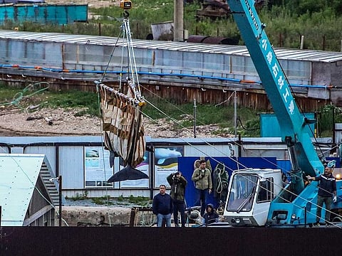 In this  June 20, 2019 file photo, workers move a whale by a crane in Srednyaya Bay, out of Vladivostok, Russia.  