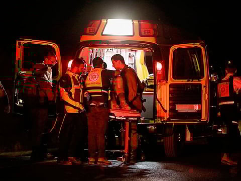 Medics evacuate soldiers who were wounded in an alleged car-ramming attack as they were stationed on a roadside near the Palestinian town of Hizma.