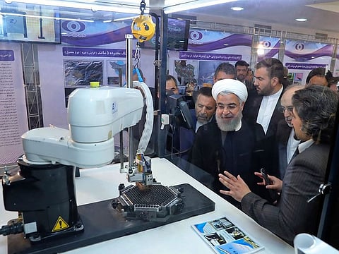 President Hassan Rouhani listens to explanations on new nuclear achievements at a ceremony to mark "National Nuclear Day," in Tehran last year.