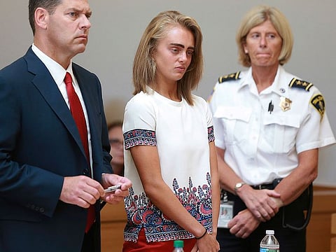 In this Aug. 3, 2017 file photo Michelle Carter, center, listens to her sentencing for involuntary manslaughter for encouraging 18-year-old Conrad Roy III to kill himself in July of 2014.