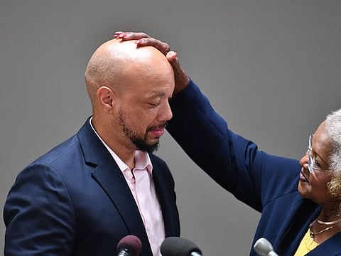 Maryland Sen. Joanne Benson, a Democrat, gives former pupil Curtis Brooks a pat on the head at St. Margaret's Catholic Church in Capital Heights, Maryland.