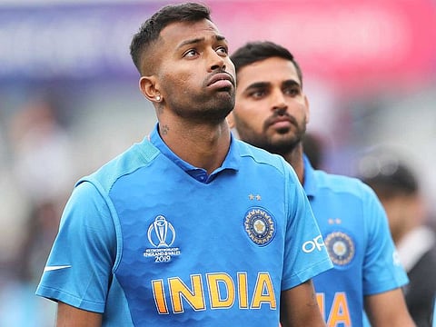 India's Hardik Pandya, left, reacts after their loss in the Cricket World Cup semi-final match against New Zealand at Old Trafford in Manchester. 