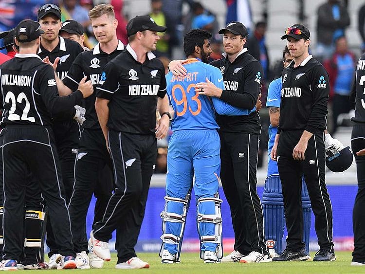 New Zealand's Martin Guptill (C-R) embraces India's Jasprit Bumrah