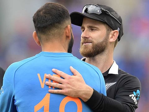 New Zealand's captain Kane Williamson (R) greets India's captain Virat Kohli at the end of play during the World Cup first semi-final at Old Trafford in Manchester, on July 10, 2019. 