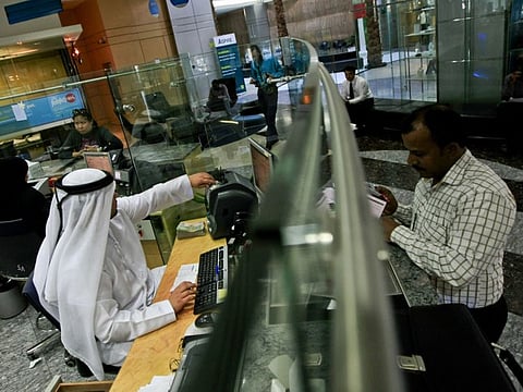 Teller at a bank in Dubai. 