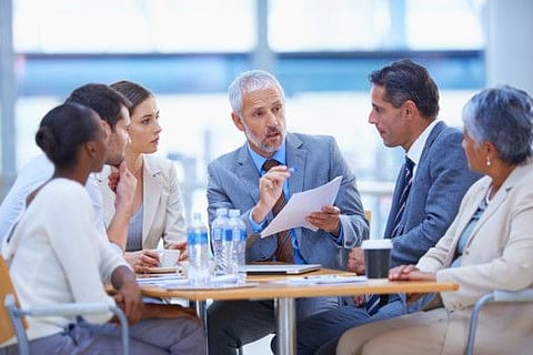 A cropped shot of a businessman sharing an idea with colleagues at a meeting