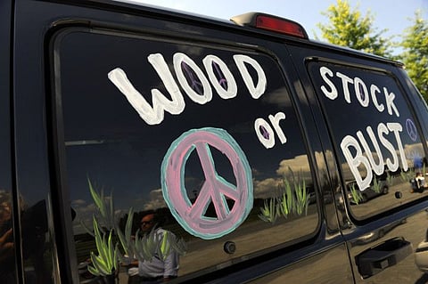 FILE - This Aug. 14, 2009 file photo shows a van decorated with "Woodstock or Bust" at the original Woodstock Festival site in Bethel, N.Y.  On Thursday, May 9, 2019, a judge in New York has ordered London-based Dentsu Aegis Networks not to make any further comments on the future of the 50th Anniversary Festival at least until a hearing on Monday, May 13.  after the festival's organizers sued the former investor. Festival organizers brought suit claiming that the former investor was verbally sabotaging the August 2019 event. (AP Photo/Stephen Chernin, File)