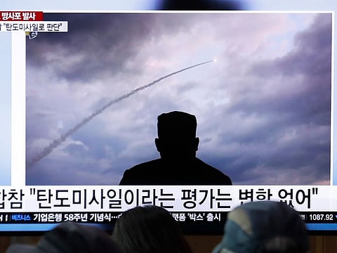 People watch a TV showing an image of North Korea's a multiple rocket launch during a news program at the Seoul Railway Station in Seoul, South Korea.