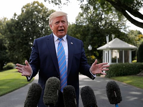 President Donald Trump speaks to reporters before departing the White House in Washington.