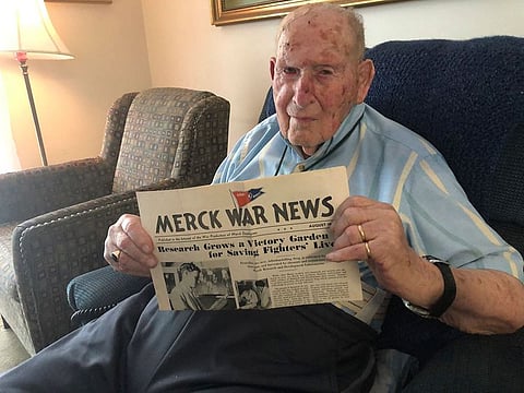 Retired chemist Robert Walton, 103, displays an August 1943 copy of Merck War News which featured a photo and article about his work during World War II helping expand production of penicillin at Merck & Co. in New Jersey, on Monday, July 29, 2019, in Columbus, Ohio. 