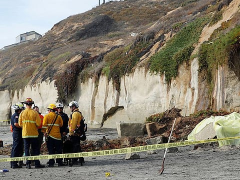 Emergency responders attend to a cliff collapse at a beach in Encinitas, California, U.S., August 2, 2019.