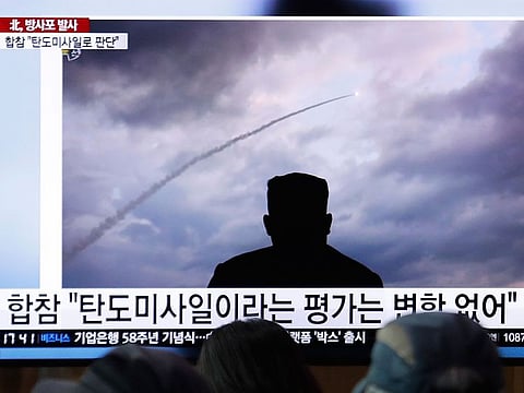 People watch a TV showing an image of North Korea's a multiple rocket launch during a news program at the Seoul Railway Station in Seoul, South Korea.