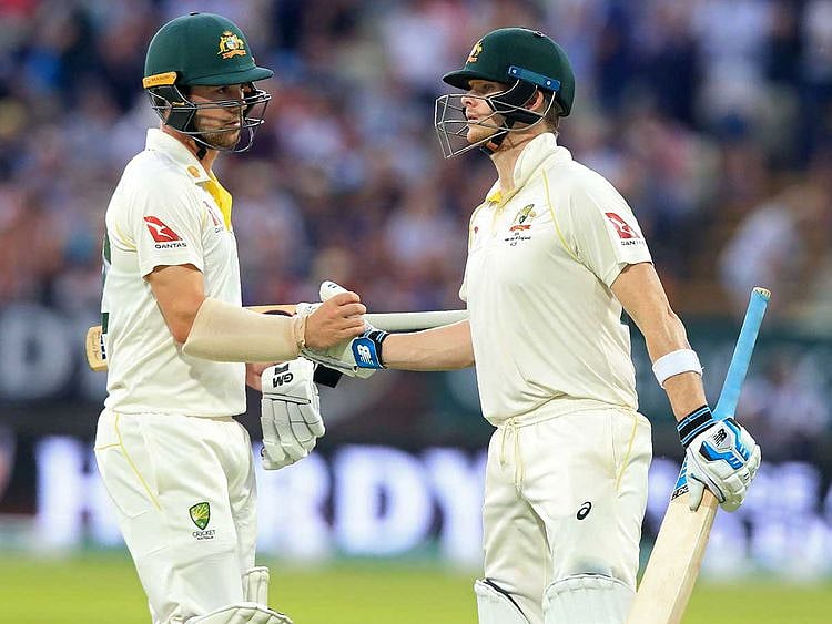 Australia's Travis Head (L) gestures to Australia's Steve Smith