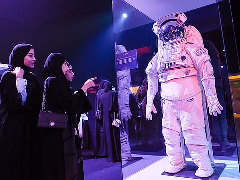 Visitors looking at the Extravehicular Mobility Unit, a space suit that provides environmental protecton, mobility, life support and communications for astronauts outside the spacecraft, at the Mohammad Bin Rashid Space Centre's Science event in Dubai on Monday 21 January 2019.