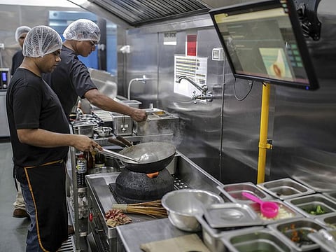 An employee cooks food inside Rebel Foods's cloud kitchen in Mumbai on May 2, 2019. 