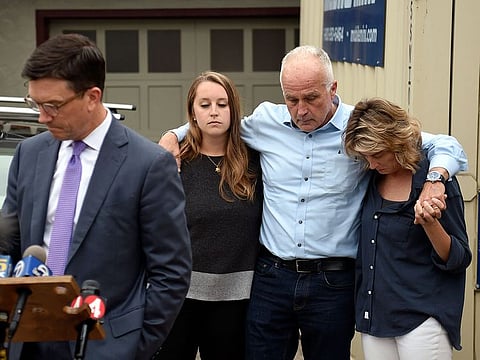 Family members of Finnegan Elder embrace as their family attorney Craig Peters, left, speaks to members of the media in front of their home in San Francisco on Saturday, Aug. 3, 2019. Elder is one of two American teenagers jailed in Rome as authorities investigate their alleged roles in the fatal stabbing of an Italian police officer on a street near their hotel. 