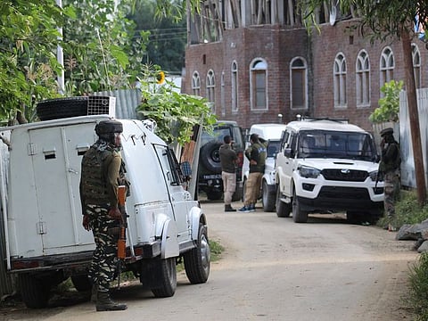 Security personnel at the site of the gunfight between security forces and militants in Sopore of Jammu and Kashmir's Baramulla district on Saturday. 