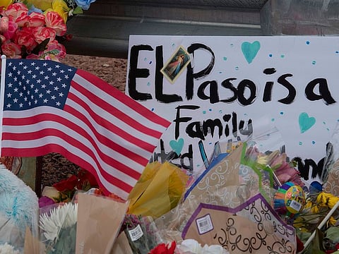 The US flag and flowers at a makeshift memorial outside the Cielo Vista Mall Wal-Mart where a shooting left 20 people dead in El Paso, Texas, on August 4, 2019.
