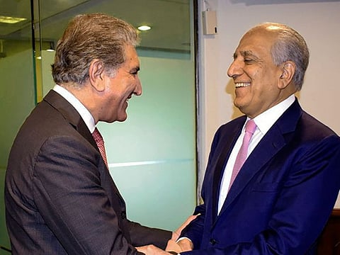 Pakistan's Foreign Minister Shah Mehmood Qureshi, left, receives U.S. envoy Zalmay Khalilzad at the Foreign Ministry in Islamabad, Pakistan, Thursday, Aug. 1, 2019. Khalilzad had hinted that a peace agreement could be reached in the next round of talks with the Taliban, potentially delivering an end to the nearly 18-year war, America's longest.