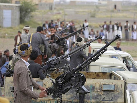 Al Houthi rebel fighters ride on gun trucks during a gathering aimed at mobilising more fighters in Sanaa, Yemen.