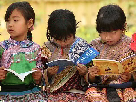  Girls from an indigenous community read outdoors at Ban Pho Primary School in Bac Han District in remote Lao Cai Province, Viet Nam