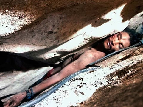 In this photo provided by Battambang province Authority Police, Sum Bora, a 28-year-old man who got stuck in the rock's hollow at Battambang province in northwestern of Phnom Penh, Cambodia, Wednesday, Aug. 7, 2019.