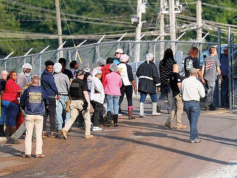Workers exit a Koch Foods Inc processing plant in Morton. US immigration officials raided several Mississippi food processing plants targeting owners as well as employees.