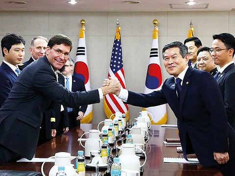 U.S. Defense Secretary Mark Esper clasps hands with South Korean Defense Minister Jeong Kyeong-doo during their meeting in Seoul, South Korea.