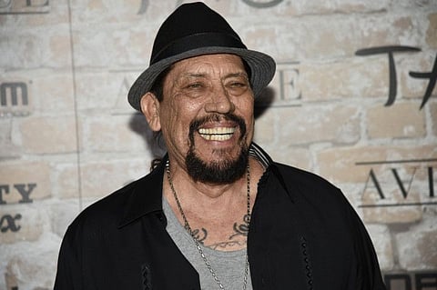 FILE - In this March 16, 2017 file photo, actor Danny Trejo arrives at the TAO, Beauty and Essex, Avenue and Luchini Los Angeles grand opening. Trejo played a real-life hero Wednesday, Aug. 7, 2019 when he helped rescue a baby trapped in an overturned car after a collision at a Los Angeles intersection. Trejo says he crawled into the wrecked vehicle from one side and, with the help of another bystander, a young woman, they pulled the baby safely from the wreckage. Trejo, an LA native, is best known for playing the character Machete from the “Spy Kids” series. (Photo by Chris Pizzello/Invision/AP, File)
