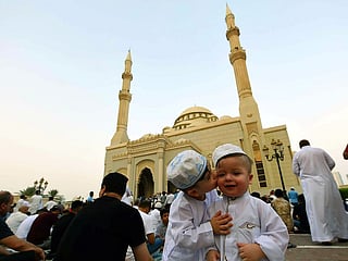 Maan Al Shaar kissing his brother Omer Al Al Shaar after Eid Al Adha prayers at Al Noor Masjid in Sharjah on Eid