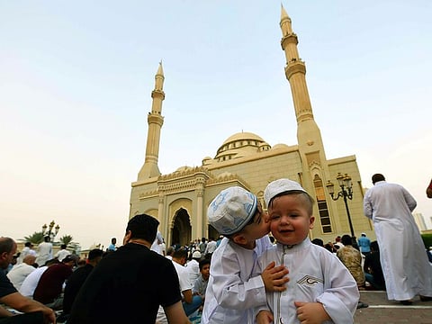 Maan Al Shaar kissing his brother Omer Al Al Shaar after Eid Al Adha prayers at Al Noor Masjid in Sharjah yesterday.