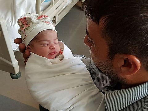 Kamal Abdul Hamid Sayyah with his newborn daughter.