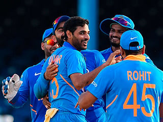 Bhuvneshwar Kumar (C) of India celebrates the dismissal of Roston Chase (not pictured) of West Indies during the 2nd ODI match at Queens Park Oval in Port of Spain, Trinidad and Tobago, on August 11, 2019.  