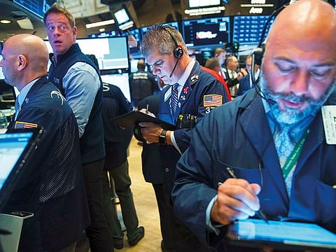 Traders work on the floor of the New York Stock Exchange on Tuesday. The S&P 500 Index recouped its Monday’s losses in early trade after Trump administration extended a grace period before tariffs take effect on a broad range of consumer goods.
