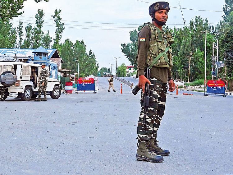 Security personnel stand guard during a lockdown in Srinagar