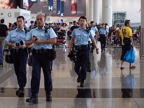 Police officers patrol in the departures hall of Hong Kong's International airport.