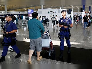 Hong Kong airport reopens, official China newspaper urges end to violence