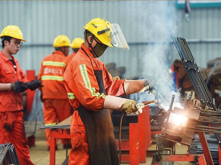 Staff working on rebars at a factory in Hangzhou in China