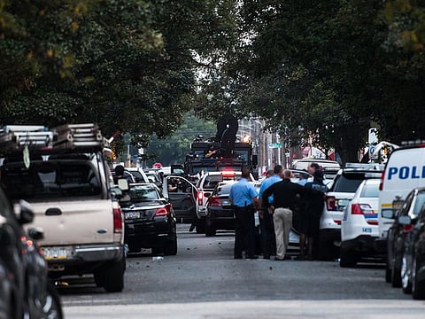 A SWAT vehicle is parked near an "active and ongoing" shooting where several officers were injured, according to authorities, after they tried to serve a narcotics warrant at a home two miles north of Temple University in Philadelphia, on Wednesday, Aug. 14, 2019.