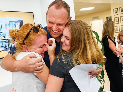 Parents celebrate with a student after the A-level results at GEMS Jumeirah College in Dubai on Thursday.. 