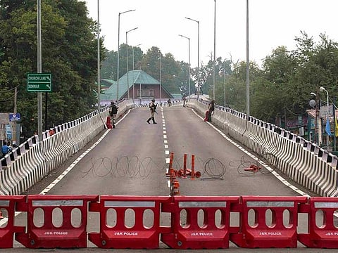 Indian paramilitary soldiers stand guard on a flyover during lockdown in Srinagar, Indian controlled Kashmir, Thursday, Aug. 15, 2019.
