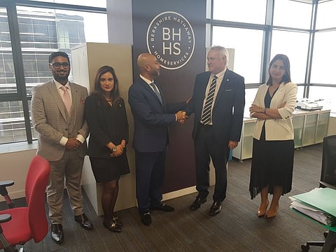 IBC Group’s Khurram Shroff (centre) and Phil Sheridan of BHHS seal the agreement. From left: Saif Ali Shroff and Sanam Shroff of IBC Group and Dounia Fadi of BHHS