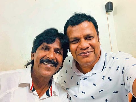 Noushad (left) with Afi Ahmad at the former’s house in Kerala on Thursday. Ahmad decided to meet Noushad and gift him money after watching a Facebook video of the street vendor donating 10 sacks of clothes to flood victims.