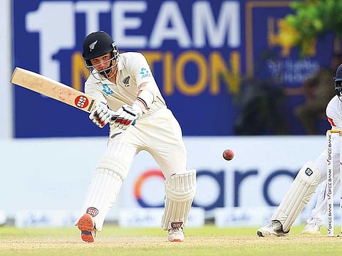 New Zealand batsman B.J. Watling plays a shot as  Sri Lankan wicketkeeper Niroshan Dickwella looks on during the third day of the first Test in Galle.