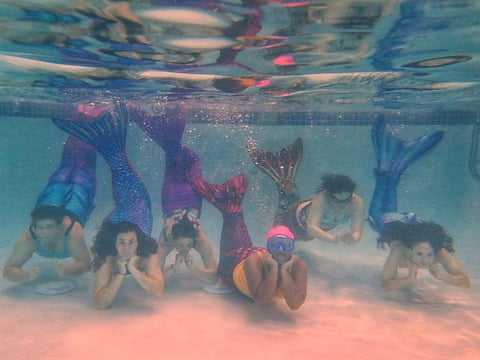 Participants pause underwater during a Metro Merfolk class in Washington, D.C. 